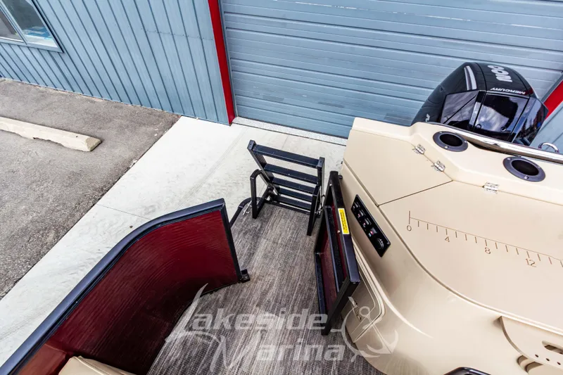 Slide: The Image of 2023 Godfrey Sweetwater 2286 FS boat with Mercury engine, docked near a blue building. - 34