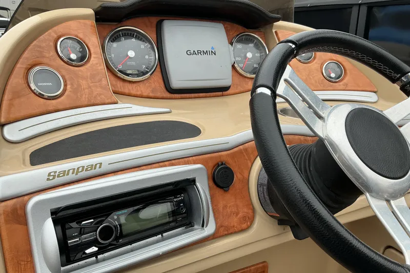 Slide: The Image of 2013 Godfrey Sanpan SP2200 BC3 dashboard with Garmin display and steering wheel. - 14