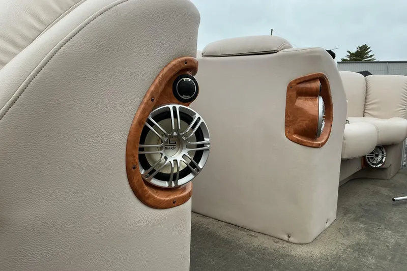 Slide: The Image of 2013 Godfrey Sanpan SP2200 BC3 boat interior with premium speakers and beige seating. - 16