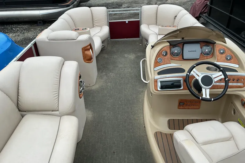 Slide: The Image of Interior of a 2013 Godfrey Sanpan SP2200 BC3 pontoon boat with beige seating and control panel. - 8