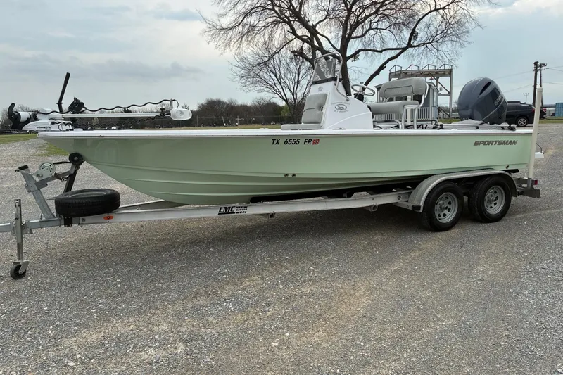 Slide: The Image of 2020 Sportsman Tournament 214 SBX Bay Boat on trailer, parked outdoors. - 1