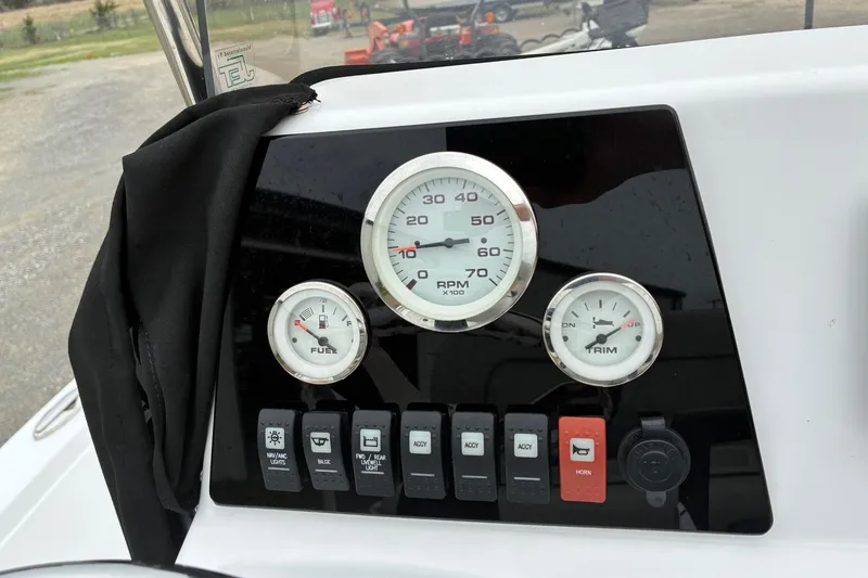 Slide: The Image of Dashboard of a 2020 Sportsman Tournament 214 SBX Bay Boat with gauges and switches. - 12