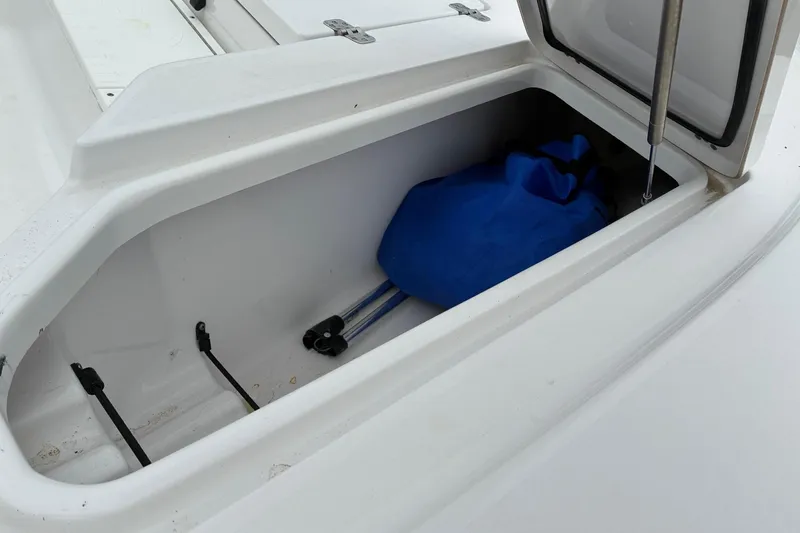 Slide: The Image of Open storage compartment on 2020 Sportsman Tournament 214 SBX Bay Boat with blue bag inside. - 8