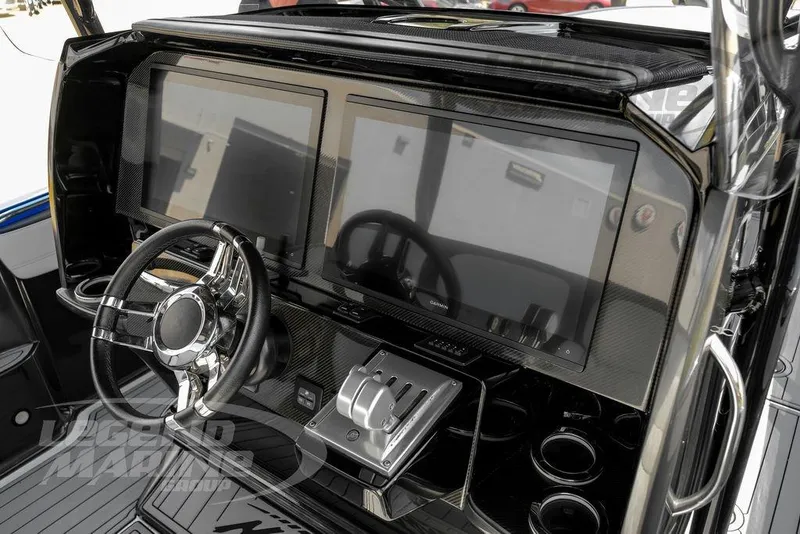 Slide: The Image of 2023 Nor-Tech 390 Sport Center Console dashboard with dual screens and sleek steering wheel. - 10