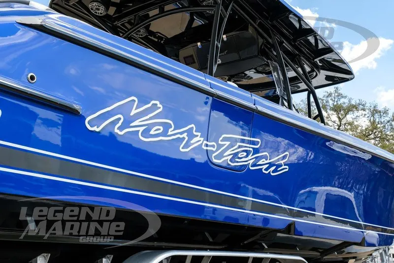 Slide: The Image of Trailer tire supporting a 2023 Nor-Tech 390 Sport Center Console boat. - 100