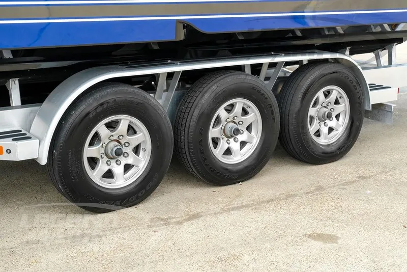 Slide: The Image of Trailer wheels of a 2023 Nor-Tech 390 Sport Center Console boat. - 103