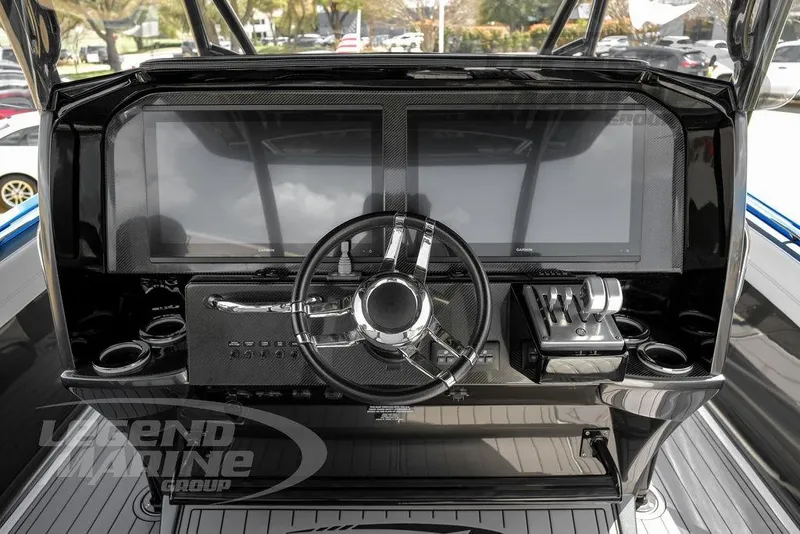 Slide: The Image of 2023 Nor-Tech 390 Sport Center Console dashboard with modern controls and dual screens. - 11