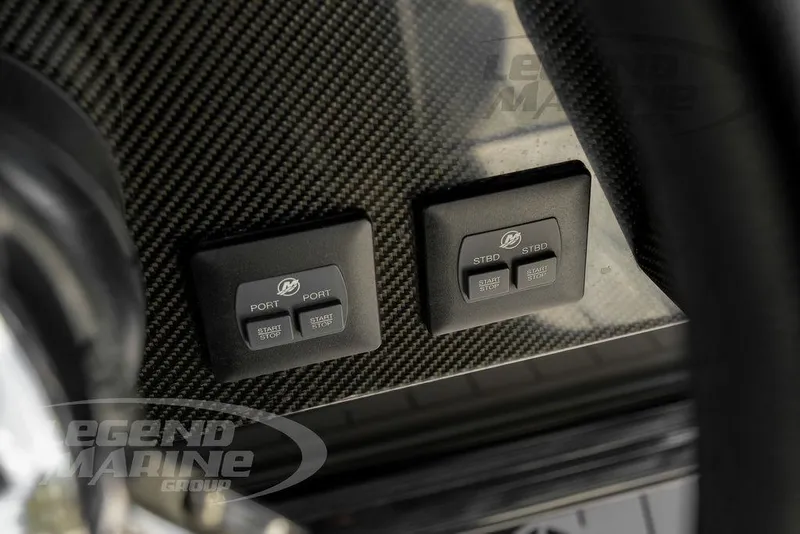 Slide: The Image of 2023 Nor-Tech 390 Sport Center Console dashboard with carbon fiber finish and control buttons. - 16