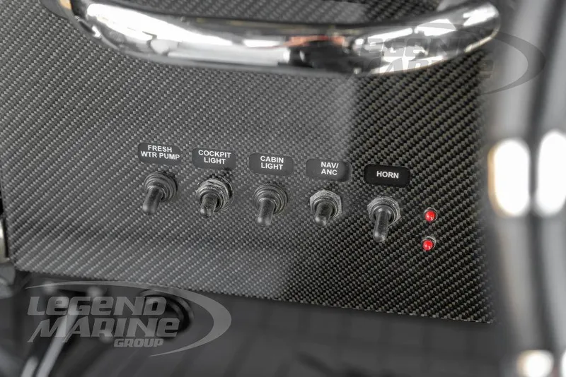 Slide: The Image of Control panel of 2023 Nor-Tech 390 Sport Center Console with labeled switches. - 17