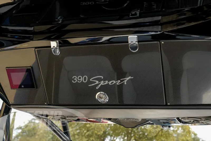 Slide: The Image of Cup holders on 2023 Nor-Tech 390 Sport Center Console boat, featuring sleek black design. - 23
