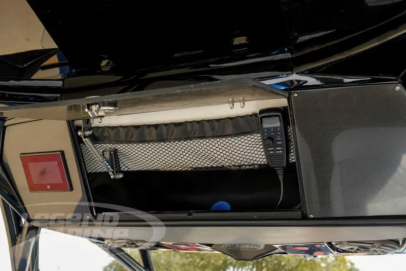 Slide: The Image of 2023 Nor-Tech 390 Sport Center Console dashboard with control buttons and carbon fiber accents. - 24