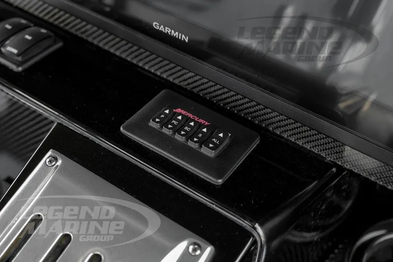 Slide: The Image of 2023 Nor-Tech 390 Sport Center Console with sleek carbon fiber cup holders. - 25