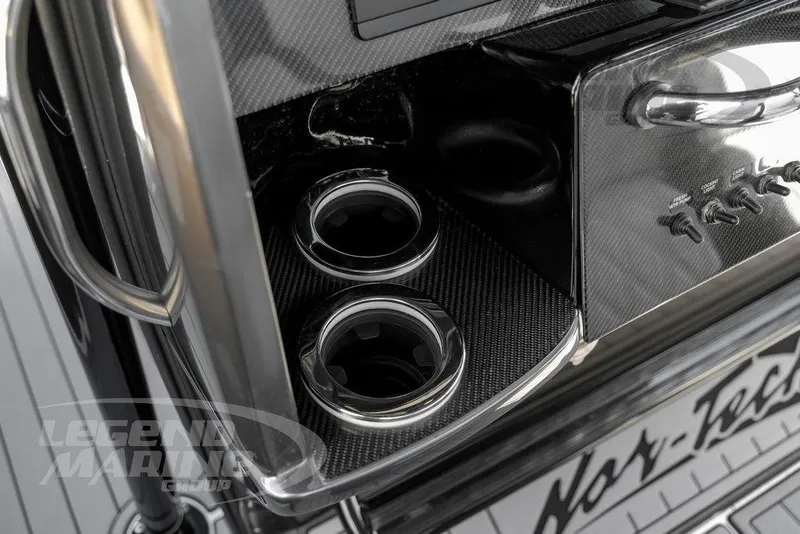 Slide: The Image of Storage compartment in 2023 Nor-Tech 390 Sport Center Console boat with radio equipment. - 28