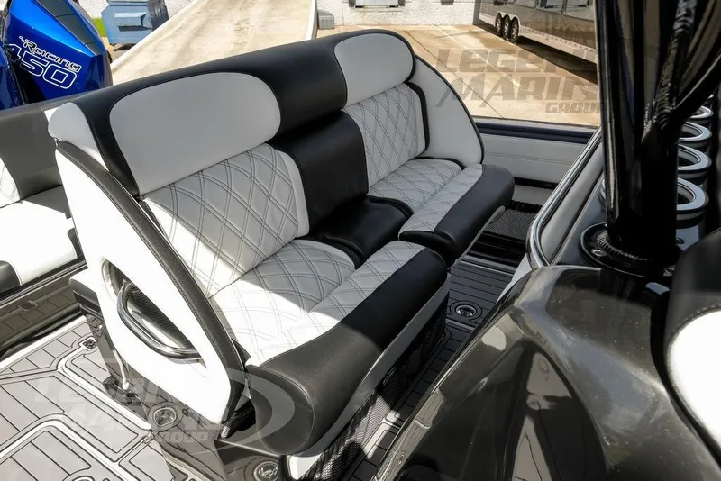 Slide: The Image of 2023 Nor-Tech 390 Sport Center Console interior with open storage compartment and luxurious seating. - 47