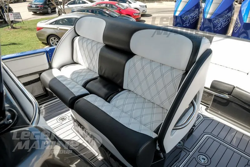 Slide: The Image of 2023 Nor-Tech 390 Sport Center Console boat with sleek design, parked near commercial buildings. - 49