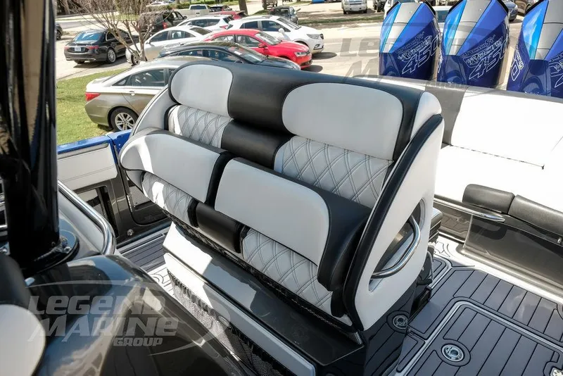 Slide: The Image of 2023 Nor-Tech 390 Sport Center Console interior storage compartment with control panel and fire extinguisher. - 50