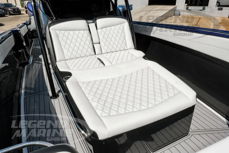 Slide: The Image of Luxurious seating on 2023 Nor-Tech 390 Sport Center Console boat, featuring diamond-stitched upholstery. - 52