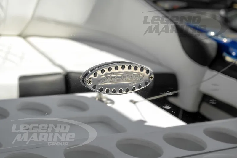 Slide: The Image of 2023 Nor-Tech 390 Sport Center Console interior detail with branded emblem and cup holders. - 61