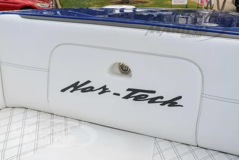 Slide: The Image of 2023 Nor-Tech 390 Sport Center Console boat interior with white seating and cup holders. - 66