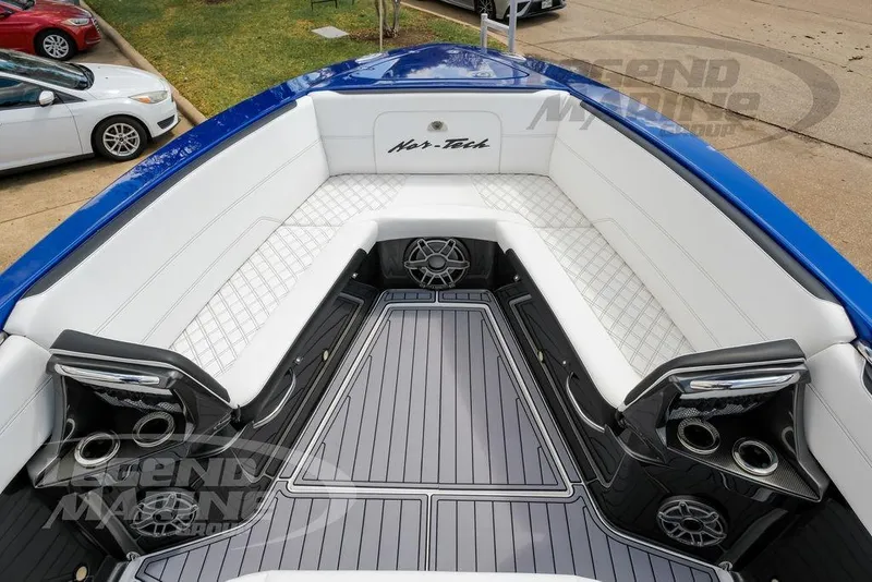 Slide: The Image of 2023 Nor-Tech 390 Sport Center Console boat interior with white seating and cup holders. - 68