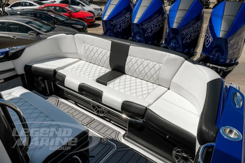 Slide: The Image of 2023 Nor-Tech 390 Sport Center Console boat interior with white seating and blue accents. - 69