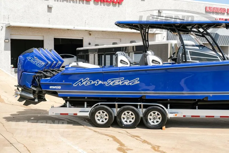 Slide: The Image of 2023 Nor-Tech 390 Sport Center Console boat in blue on a trailer. - 7