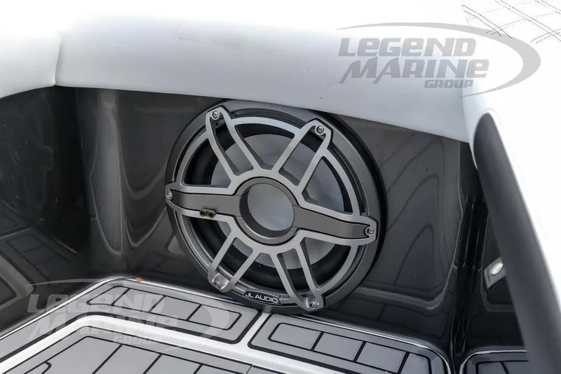 Slide: The Image of 2023 Nor-Tech 390 Sport Center Console storage compartment with white cushioned seating. - 70