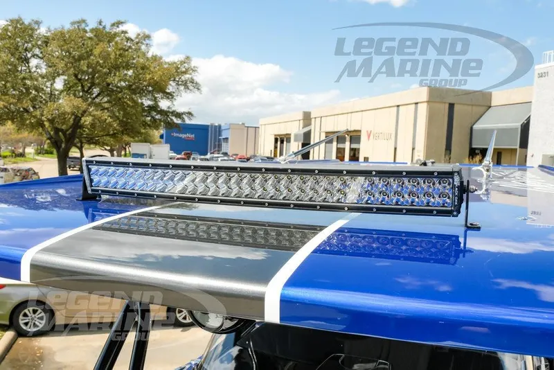 Slide: The Image of 2023 Nor-Tech 390 Sport Center Console boat with sleek black design and logo. - 91