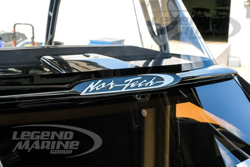 Slide: The Image of 2023 Nor-Tech 390 Sport Center Console boat with blue exterior and branding. - 94