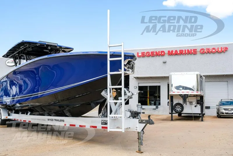 Slide: The Image of 2023 Nor-Tech 390 Sport Center Console in vibrant blue, featuring Legend Marine Group branding. - 98