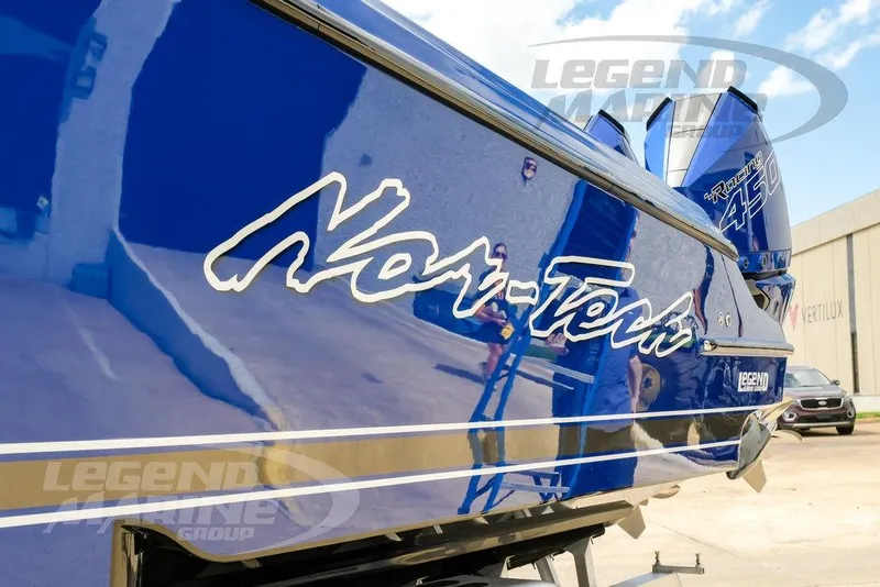 Slide: The Image of 2023 Nor-Tech 390 Sport Center Console boat with sleek blue hull and chrome anchor. - 99