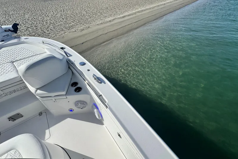 Slide: The Image of 2025 Crevalle 24 HCO boat near sandy shore and clear water. - 11