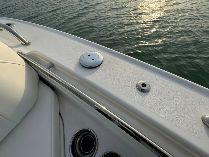 Slide: The Image of Crevalle 24 HCO 2025 boat deck with water view at sunset. - 14