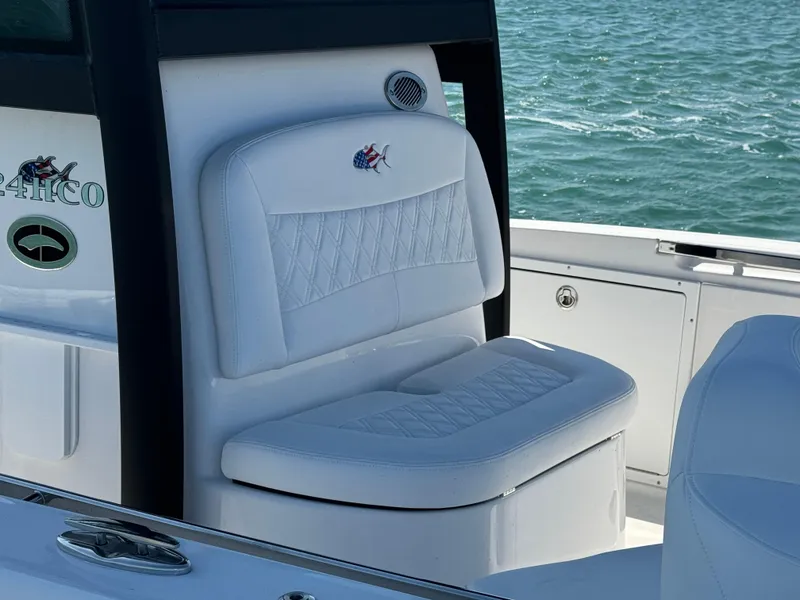 Slide: The Image of 2025 Crevalle 24 HCO boat seat with white upholstery on open water. - 18