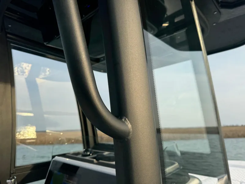 Slide: The Image of Close-up of 2025 Crevalle 24 HCO boat's interior with water view. - 22