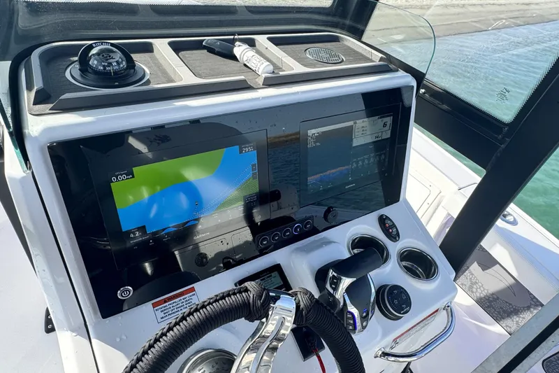 Slide: The Image of 2025 Crevalle 24 HCO boat dashboard with navigation screens and controls. - 26