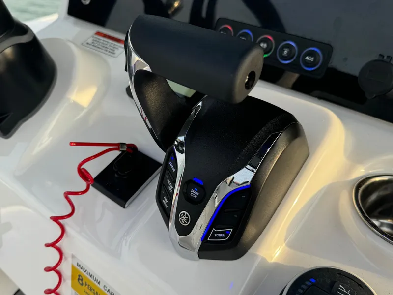 Slide: The Image of Throttle control on 2025 Crevalle 24 HCO boat dashboard with safety lanyard. - 27