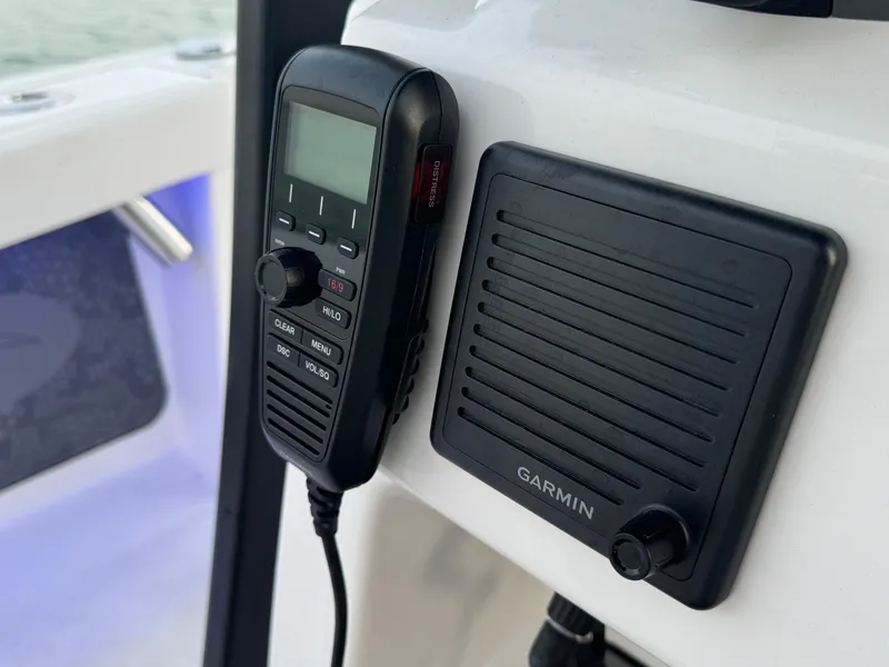 Slide: The Image of VHF radio and Garmin speaker on 2025 Crevalle 24 HCO boat dashboard. - 30