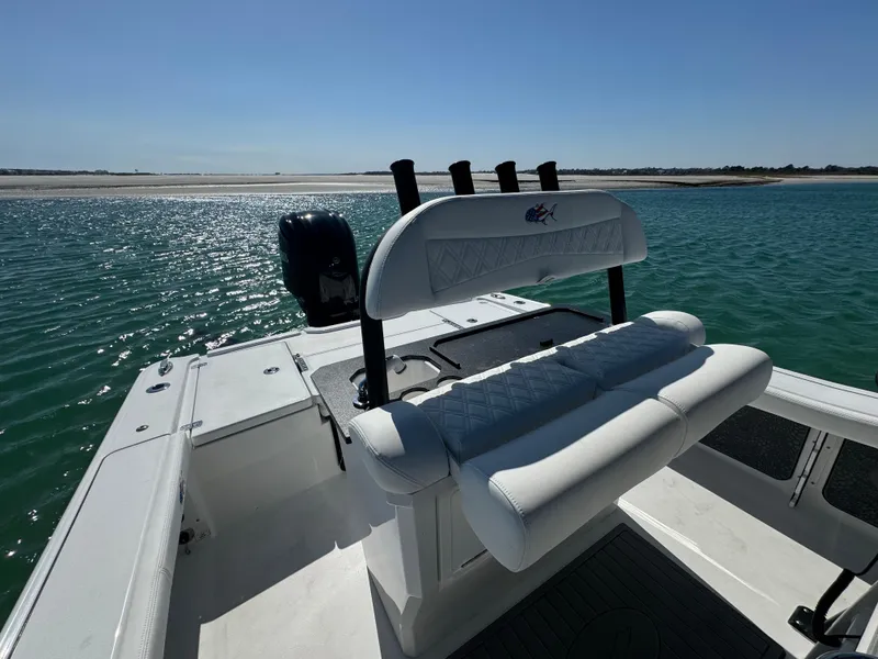 Slide: The Image of 2025 Crevalle 24 HCO boat on water, featuring sleek seating and rod holders. - 32