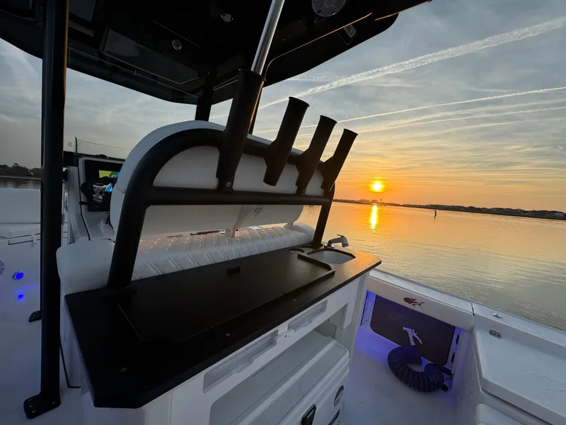 Slide: The Image of Crevalle 24 HCO boat at sunset on calm waters, 2025 model. - 39