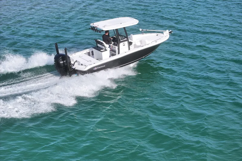 Slide: The Image of 2025 Crevalle 24 HCO boat cruising on clear blue water. - 4