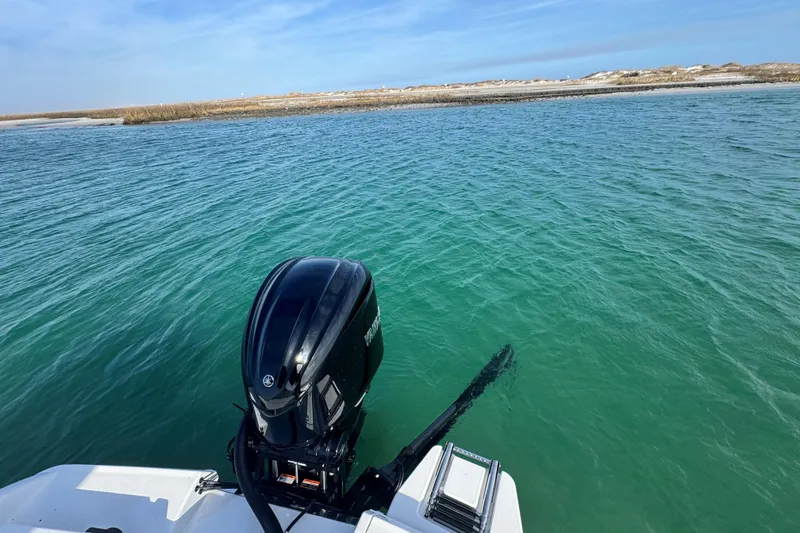 Slide: The Image of Crevalle 24 HCO 2025 boat with Yamaha outboard on clear turquoise water. - 47