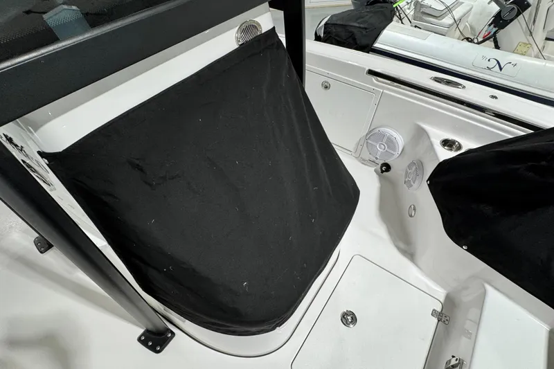 Slide: The Image of 2025 Crevalle 24 HCO boat interior with black cover and speaker detail. - 52