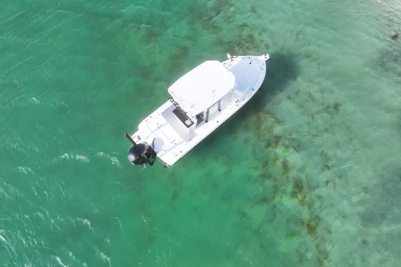 Slide: The Image of Aerial view of 2025 Crevalle 24 HCO boat on clear turquoise water. - 6