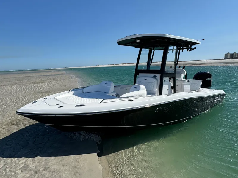 Slide: The Image of 2025 Crevalle 24 HCO boat on sandy shore with clear blue water. - 7