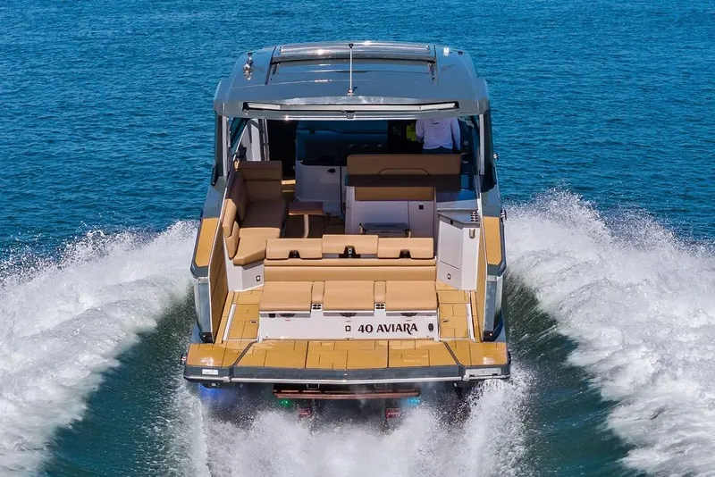 Slide: The Image of 2022 Aviara AV40 OB luxury boat cruising on open water. - 12
