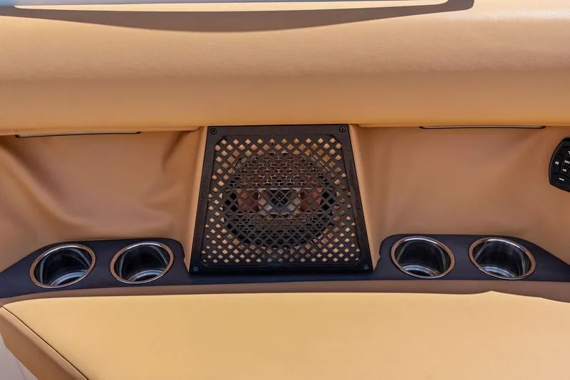 Slide: The Image of 2022 Aviara AV40 OB interior with speaker and cup holders in tan upholstery. - 16