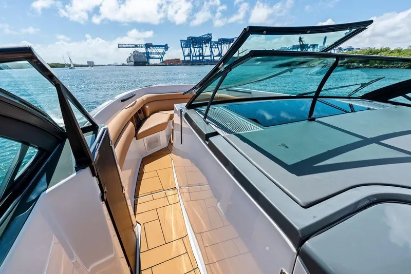 Slide: The Image of 2022 Aviara AV40 OB luxury boat with open deck and scenic waterfront view. - 17
