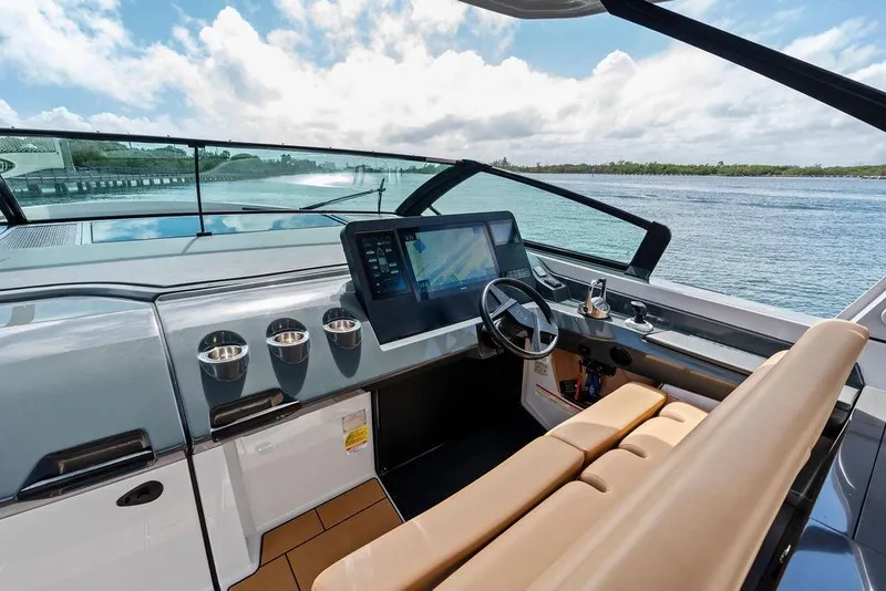 Slide: The Image of 2022 Aviara AV40 OB boat cockpit with modern controls and scenic water view. - 37