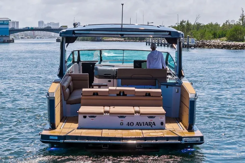 Slide: The Image of 2022 Aviara AV40 OB luxury boat cruising on a scenic waterway. - 11
